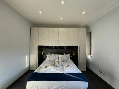a bedroom with a large bed with two pillows at G&G Apartment in Rome Quadraro in Rome