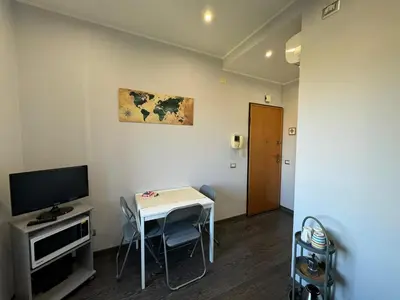 a small room with a table and a television at G&G Apartment in Rome Quadraro in Rome