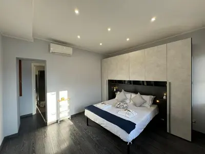 a bedroom with a large bed with a large headboard at G&G Apartment in Rome Quadraro in Rome