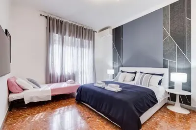 a bedroom with two beds and a window at BDC - Rome, Open City! 3-BDR! in Rome