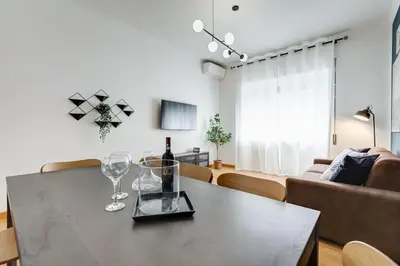 a living room with a table with wine glasses on it at BDC - Rome, Open City! 3-BDR! in Rome