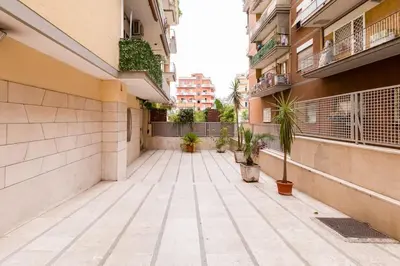 an empty courtyard of a building with potted plants at BDC - Rome, Open City! 3-BDR! in Rome