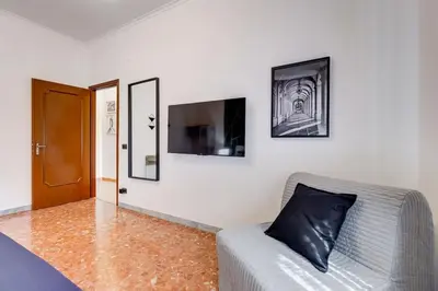a living room with a couch and a television at BDC - Rome, Open City! 3-BDR! in Rome