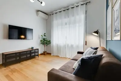 a living room with a couch and a flat screen tv at BDC - Rome, Open City! 3-BDR! in Rome