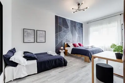a bedroom with two beds and a table at BDC - Rome, Open City! 3-BDR! in Rome