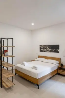 a bedroom with a large bed and a shelf at When in Rome in Rome