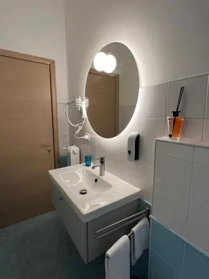 a bathroom with a sink and a mirror at Maison Roberto in Rome