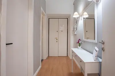 a white bathroom with a sink and a mirror at Veniero Apartment in Rome