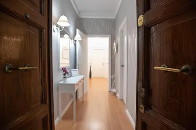 a room with a hallway with a door and a table at Veniero Apartment in Rome