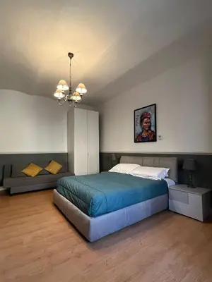 a bedroom with a bed and a couch at Veniero Apartment in Rome