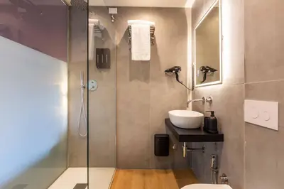 a bathroom with a shower with a sink and a toilet at LUMINA3 Luxury Room ROME in Rome