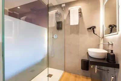 a bathroom with a sink and a glass shower at LUMINA3 Luxury Room ROME in Rome