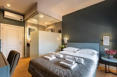 a bedroom with a large bed with towels on it at LUMINA3 Luxury Room ROME in Rome