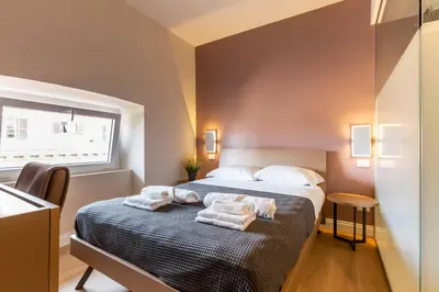 a bedroom with a bed with towels on it at LUMINA3 Luxury Room ROME in Rome