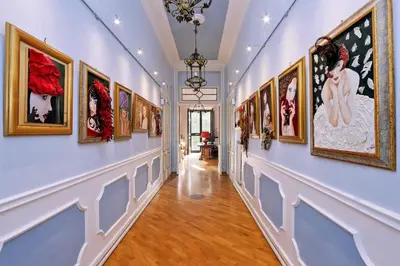 a hallway with a bunch of paintings on the wall at Domus Monamì Luxury Suites in Rome