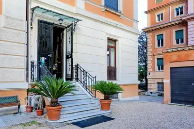an entrance to a building with potted plants at Domus Monamì Luxury Suites in Rome