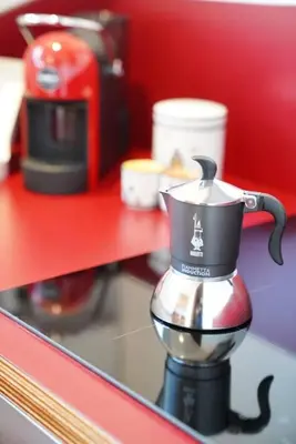 a coffee maker sitting on a red counter top at Villa Bonelli Penthouse in Rome