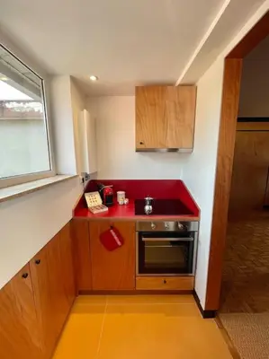 a small kitchen with a red counter top at Villa Bonelli Penthouse in Rome
