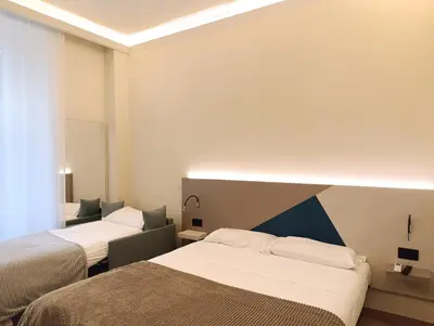 a hotel room with two beds and a couch at HoneyComb GuestHouse in Rome