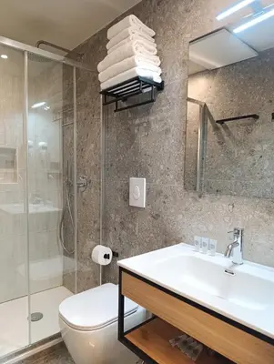 a bathroom with a sink and a toilet and a shower at HoneyComb GuestHouse in Rome
