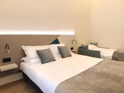 two beds in a hotel room with two beds at HoneyComb GuestHouse in Rome