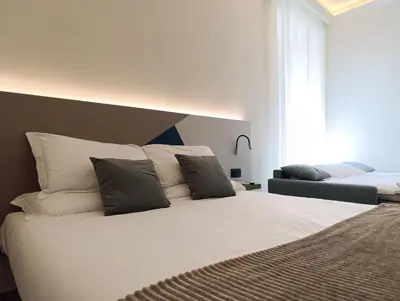 a bedroom with a large white bed with pillows at HoneyComb GuestHouse in Rome