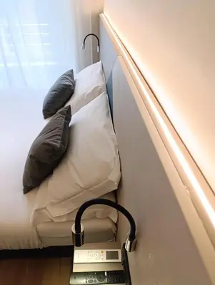 a room with a bed with a scale next to it at HoneyComb GuestHouse in Rome