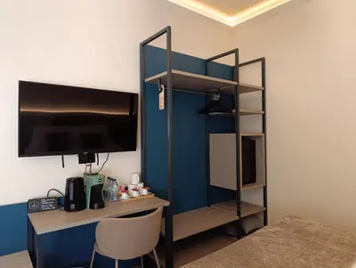 a room with a desk with a computer and a shelf at HoneyComb GuestHouse in Rome