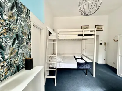 a room with two bunk beds and a wall with a mural at Pina Charme in Rome