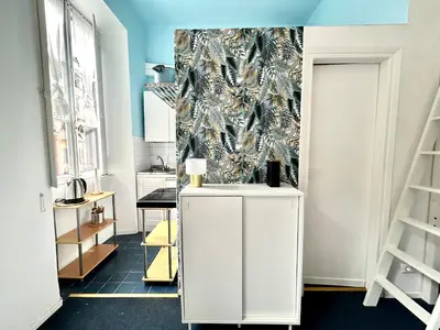 a room with a white cabinet and a wallpaper at Pina Charme in Rome