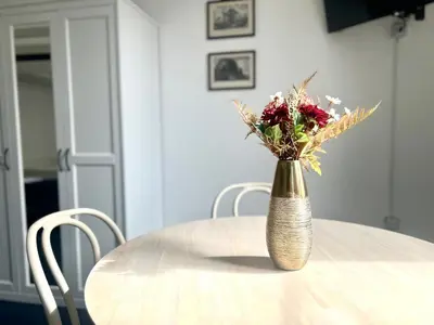 a vase filled with flowers sitting on top of a table at Pina Charme in Rome