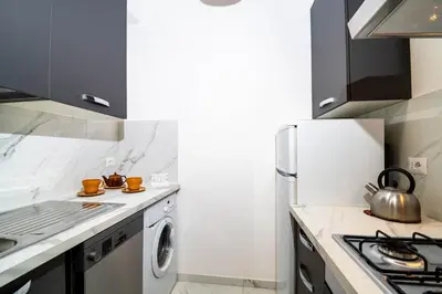 a kitchen with a refrigerator and a washing machine at House Serena in Rome