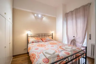 a bedroom with a bed with two towels on it at House Serena in Rome