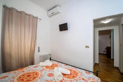 a bedroom with a bed with towels on it at House Serena in Rome