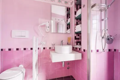 a pink bathroom with a sink and a toilet at Adelante Rooms San Giovanni in Rome