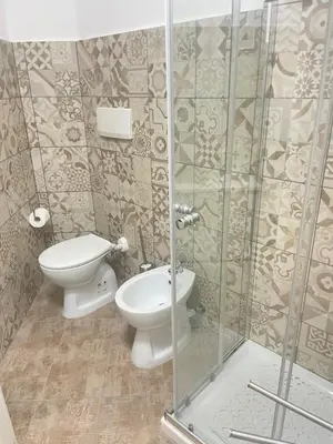a bathroom with a toilet and a glass shower at Sweet home Trastevere 2- Roma in Rome