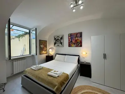 a bedroom with a bed with two towels on it at Quiet Corner in the Eternal City in Rome