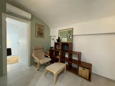 a living room with a chair and a desk at Quiet Corner in the Eternal City in Rome