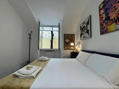 a bedroom with a large white bed and a window at Quiet Corner in the Eternal City in Rome
