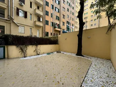 a courtyard with a tree and a building at Quiet Corner in the Eternal City in Rome