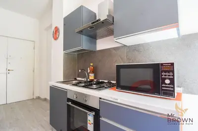 a kitchen with a microwave and a stove top oven at Orange House in Rome