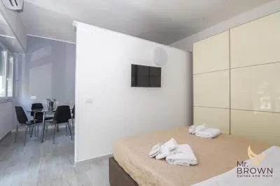 a bedroom with a bed with white towels on it at Orange House in Rome