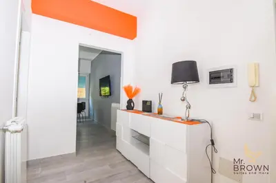 a living room with white cabinets and an orange ceiling at Orange House in Rome