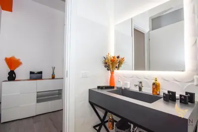 a bathroom with a sink and a mirror at Orange House in Rome