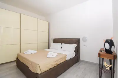 a bedroom with a bed with two towels on it at Orange House in Rome