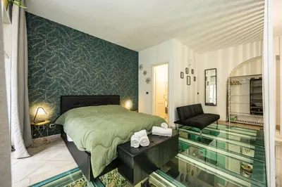 a bedroom with a bed and a swimming pool at Casa Cristallo Relax e Spa in Rome