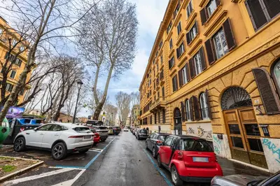 a street with cars parked on the side of a building at Casa Cristallo Relax e Spa in Rome