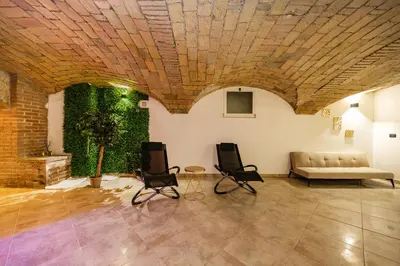 a living room with two chairs and a couch at Casa Cristallo Relax e Spa in Rome