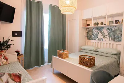 a bedroom with a bed with two baskets on it at Stefy's House in Rome