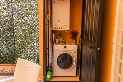 a washing machine and a washer in a room at Stefy's House in Rome